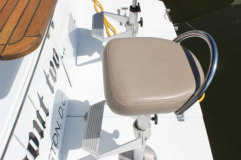  Yacht Photos Pics 2003 Carver 36 Super Sport boat seat with beige cushion and metal frame.