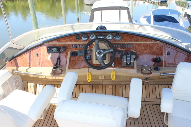  Yacht Photos Pics Cockpit of 2003 Carver 36 Super Sport yacht with wooden dashboard and white seating.