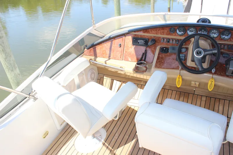  Yacht Photos Pics 2003 Carver 36 Super Sport helm with white seats and wooden dashboard.