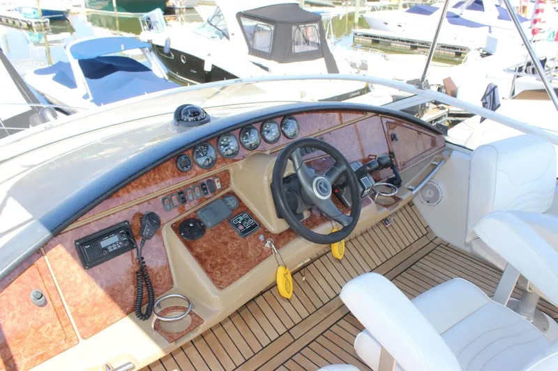  Yacht Photos Pics 2003 Carver 36 Super Sport helm with wood accents and modern controls.