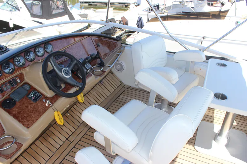  Yacht Photos Pics 2003 Carver 36 Super Sport yacht cockpit with white seats and wooden dashboard.