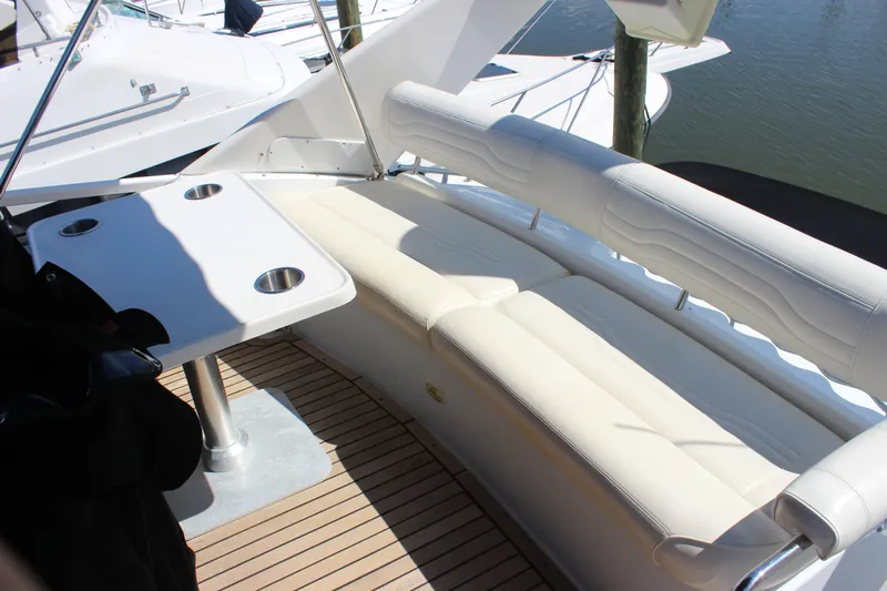  Yacht Photos Pics 2003 Carver 36 Super Sport yacht with white seating and table on deck.