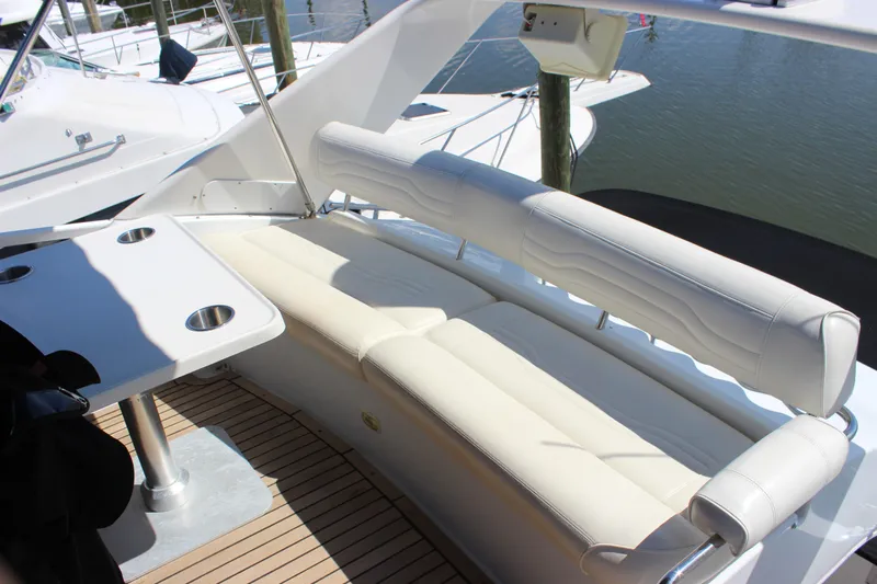  Yacht Photos Pics Luxurious seating area on 2003 Carver 36 Super Sport yacht with table and cup holders.