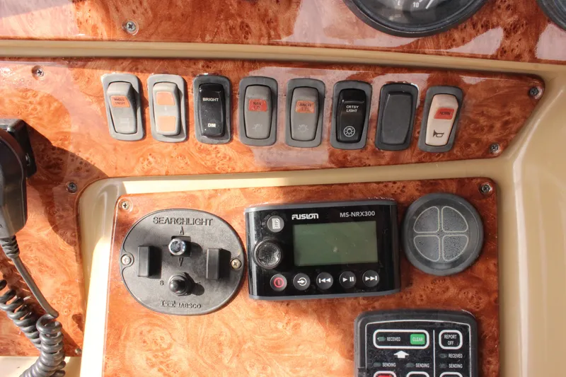  Yacht Photos Pics Control panel of a 2003 Carver 36 Super Sport boat with switches and a Fusion MS-NRX300.