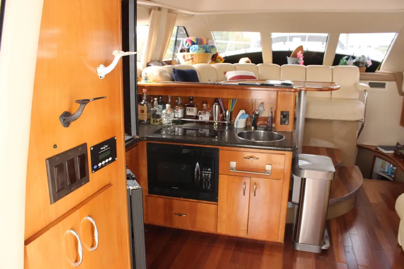  Yacht Photos Pics Interior of 2003 Carver 36 Super Sport yacht with kitchenette and seating area.