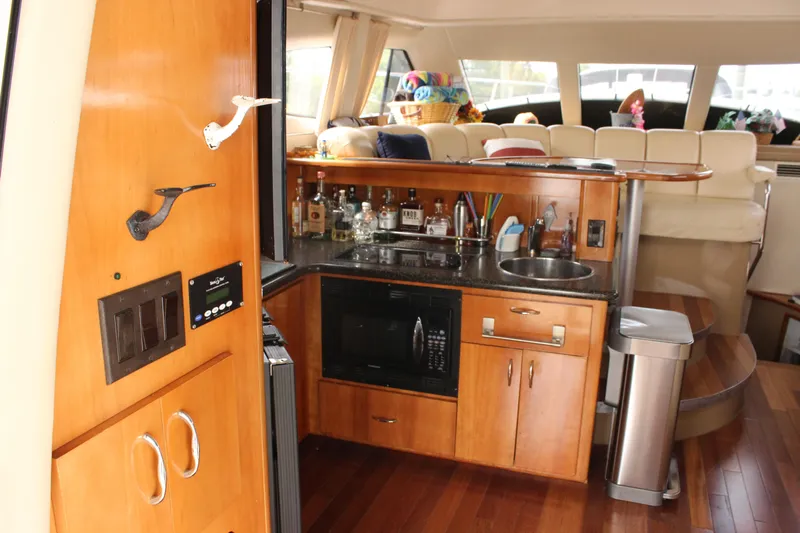  Yacht Photos Pics Interior of 2003 Carver 36 Super Sport yacht with kitchenette and seating area.