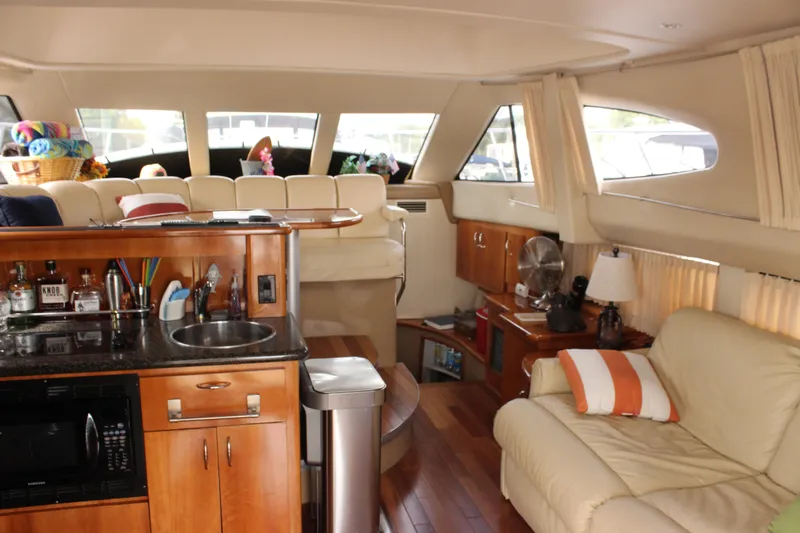  Yacht Photos Pics Luxurious interior of 2003 Carver 36 Super Sport yacht with kitchenette and seating area.