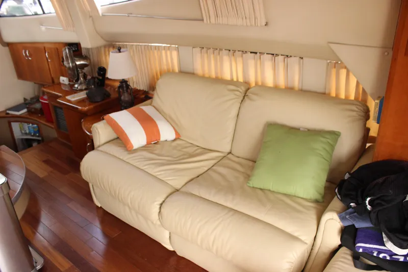  Yacht Photos Pics Luxurious interior of 2003 Carver 36 Super Sport yacht with cream sofa and colorful cushions.