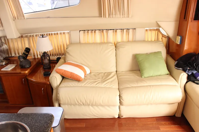  Yacht Photos Pics Interior of 2003 Carver 36 Super Sport yacht with cream leather sofa and cushions.