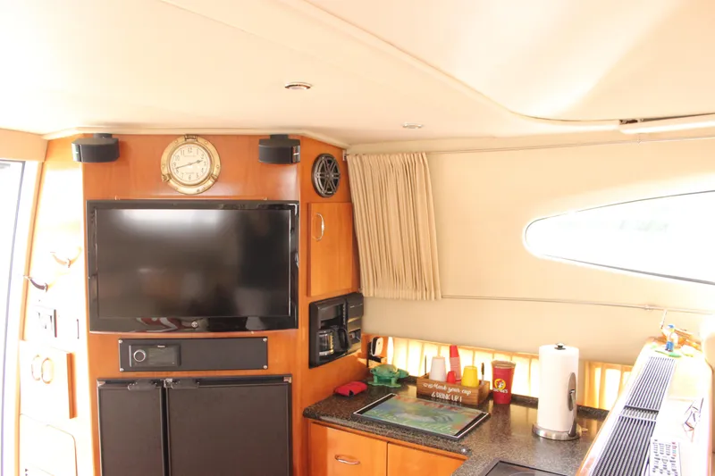  Yacht Photos Pics Interior of 2003 Carver 36 Super Sport yacht with TV and kitchenette.