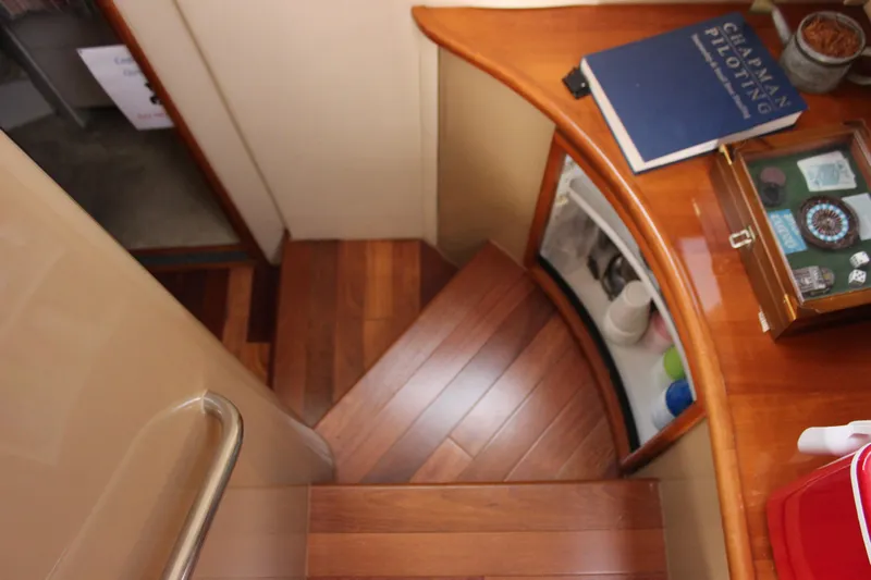  Yacht Photos Pics Interior of 2003 Carver 36 Super Sport yacht with wooden stairs and navigation book.