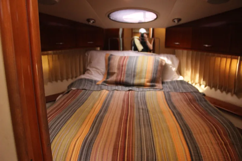  Yacht Photos Pics Interior cabin of 2003 Carver 36 Super Sport with striped bedding and wood accents.
