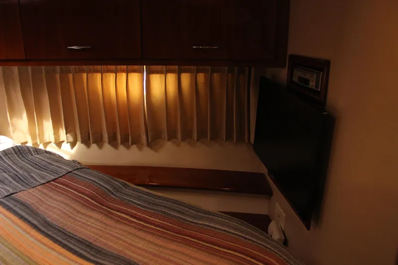  Yacht Photos Pics Cozy interior of 2003 Carver 36 Super Sport with TV and striped bedding.