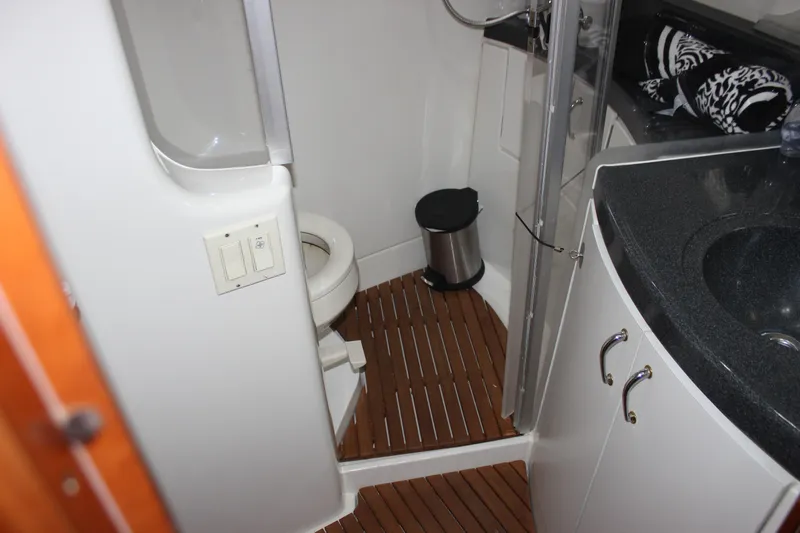  Yacht Photos Pics Bathroom interior of 2003 Carver 36 Super Sport yacht with wooden flooring and modern fixtures.
