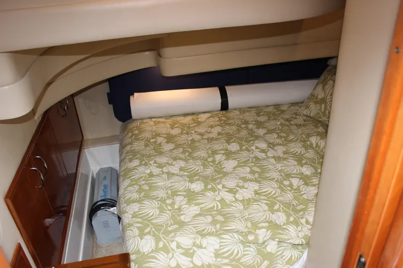  Yacht Photos Pics Interior cabin of 2003 Carver 36 Super Sport with floral bedspread and storage.