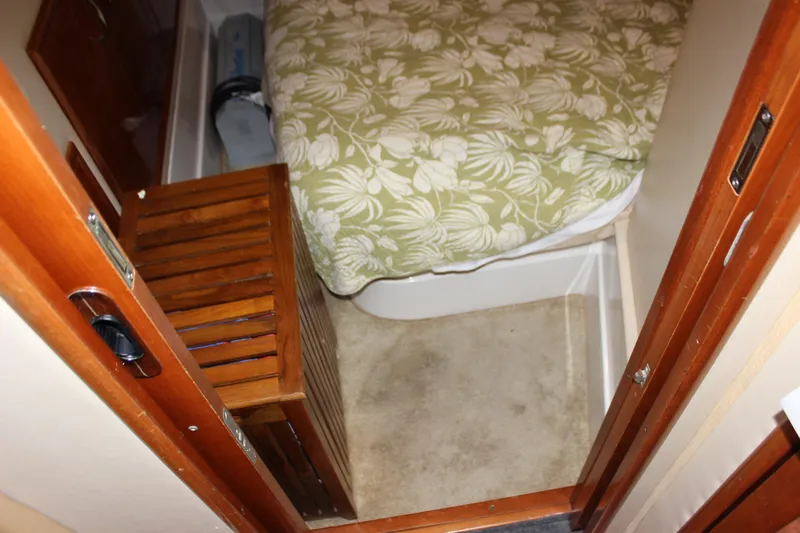  Yacht Photos Pics Interior of 2003 Carver 36 Super Sport with floral bedspread and wooden furniture.