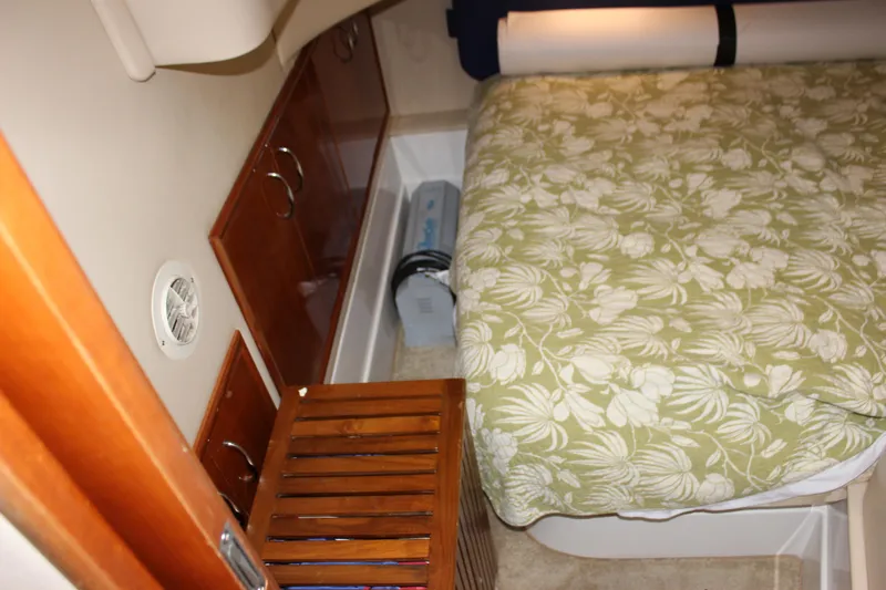  Yacht Photos Pics Interior cabin of 2003 Carver 36 Super Sport with floral bedspread and wooden storage.