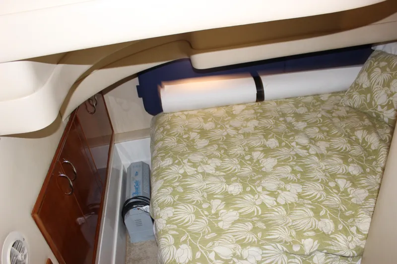  Yacht Photos Pics 2003 Carver 36 Super Sport cabin interior with floral bedding and wooden cabinetry.