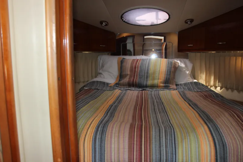  Yacht Photos Pics Cozy cabin interior of 2003 Carver 36 Super Sport with striped bedding.