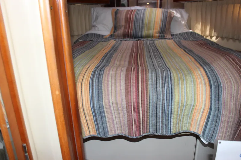  Yacht Photos Pics Cozy cabin bed with striped bedding in 2003 Carver 36 Super Sport yacht.