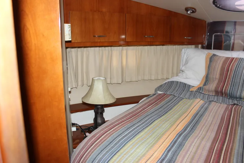  Yacht Photos Pics Cozy bedroom interior of 2003 Carver 36 Super Sport yacht with striped bedding.