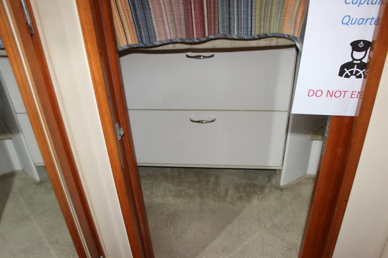  Yacht Photos Pics Interior of 2003 Carver 36 Super Sport, showing cabin entrance with drawers and sign.