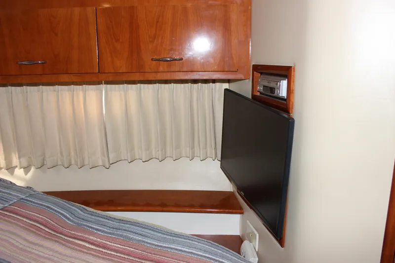  Yacht Photos Pics Interior of 2003 Carver 36 Super Sport with TV, wood cabinets, and curtains.