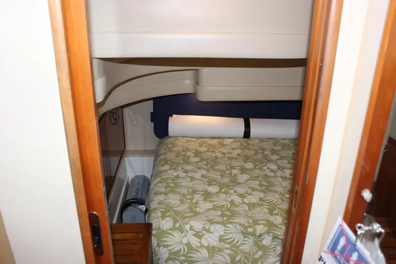  Yacht Photos Pics Interior cabin of 2003 Carver 36 Super Sport with floral bedding and wooden accents.