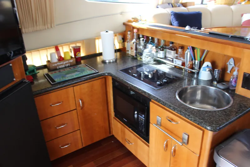  Yacht Photos Pics 2003 Carver 36 Super Sport yacht kitchen with modern appliances and wooden cabinetry.