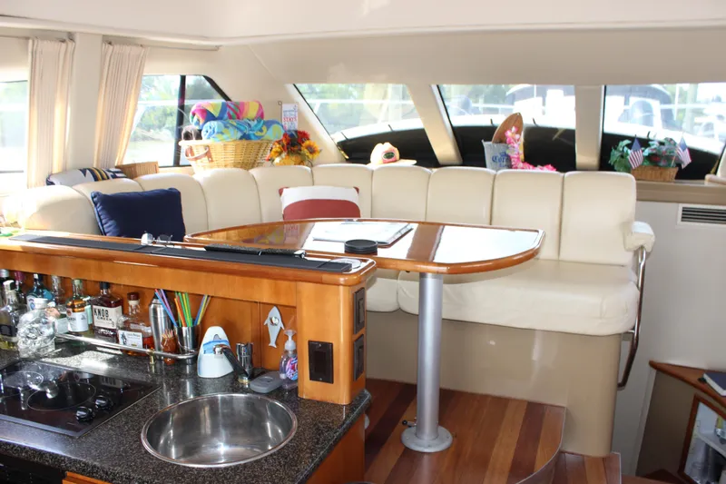  Yacht Photos Pics Luxurious interior of 2003 Carver 36 Super Sport yacht with cozy seating and bar area.