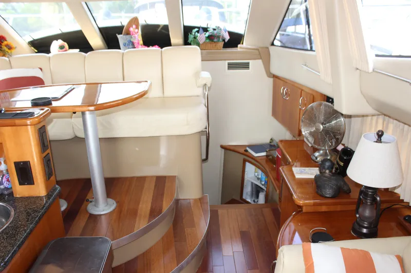  Yacht Photos Pics Interior of 2003 Carver 36 Super Sport yacht with wooden flooring and cozy seating area.