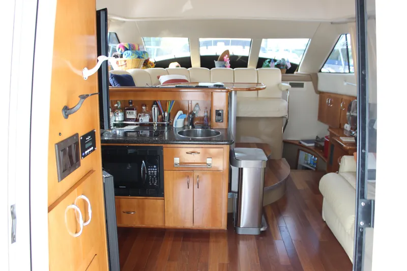  Yacht Photos Pics Interior of 2003 Carver 36 Super Sport yacht with kitchenette and seating area.