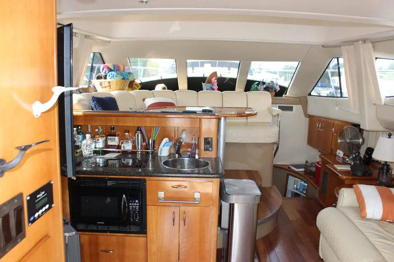  Yacht Photos Pics Interior of 2003 Carver 36 Super Sport yacht with kitchenette and seating area.