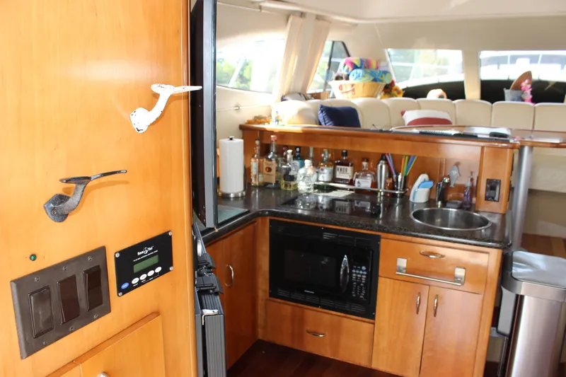  Yacht Photos Pics Interior of 2003 Carver 36 Super Sport yacht with kitchenette and bar area.