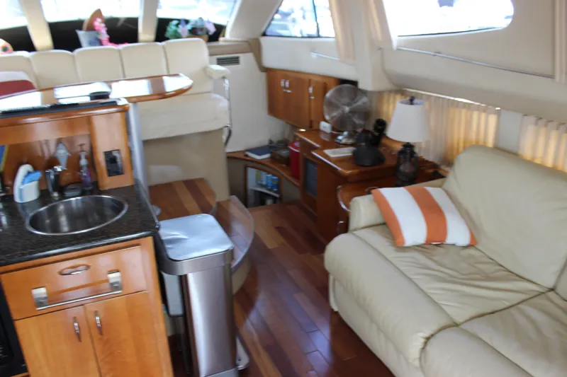  Yacht Photos Pics Interior of 2003 Carver 36 Super Sport yacht with cozy seating and kitchenette.