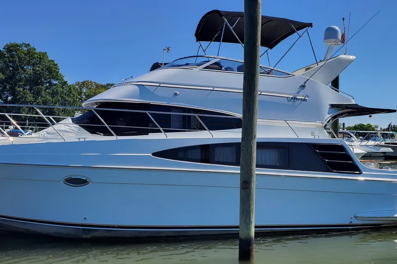  Yacht Photos Pics 2003 Carver 36 Super Sport yacht docked in marina under clear blue sky.