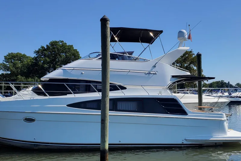  Yacht Photos Pics 2003 Carver 36 Super Sport yacht docked at marina under clear blue sky.