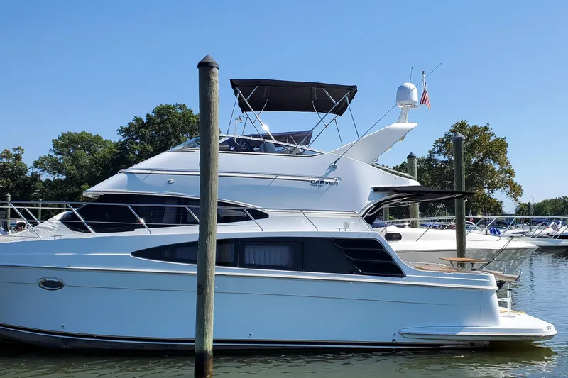  Yacht Photos Pics 2003 Carver 36 Super Sport yacht docked at marina, clear blue sky background.