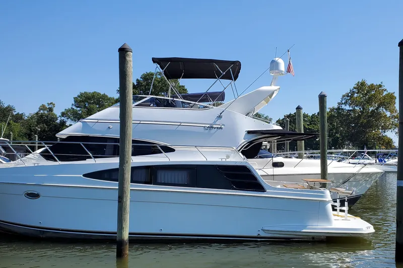  Yacht Photos Pics 2003 Carver 36 Super Sport yacht docked at marina under clear blue sky.