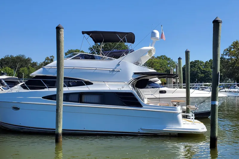  Yacht Photos Pics 2003 Carver 36 Super Sport yacht docked at marina on a sunny day.
