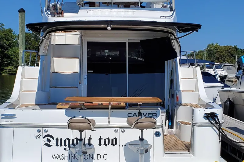  Yacht Photos Pics 2003 Carver 36 Super Sport yacht docked, featuring rear seating and "Dugout Too" name.