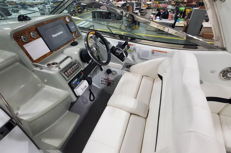  Yacht Photos Pics 2010 Formula 31 Performance Cruiser cockpit with white seating and advanced navigation controls.