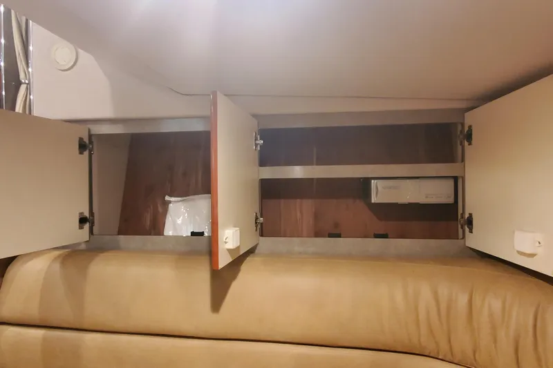  Yacht Photos Pics Open storage cabinets inside a 2010 Formula 31 Performance Cruiser boat interior.