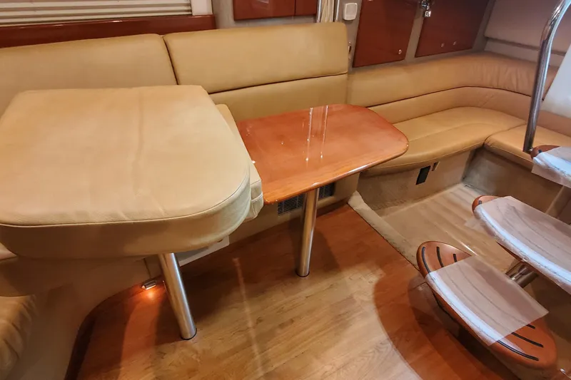  Yacht Photos Pics Interior of 2010 Formula 31 Performance Cruiser with beige seating and wooden table.