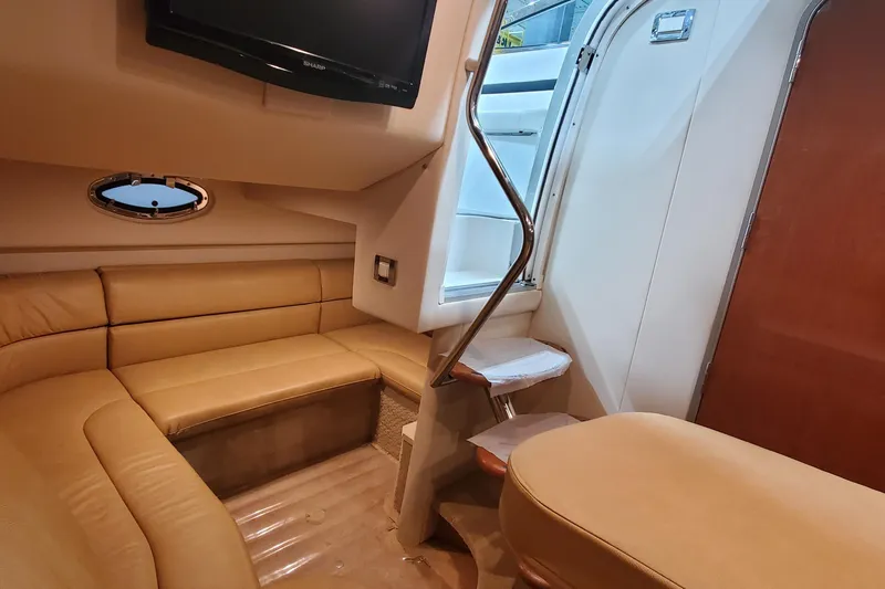  Yacht Photos Pics 2010 Formula 31 Performance Cruiser interior with beige seating and a mounted TV.