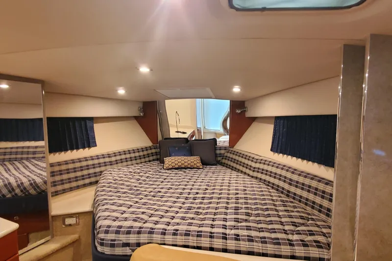  Yacht Photos Pics 2010 Formula 31 Performance Cruiser interior with plaid bedding and cozy lighting.