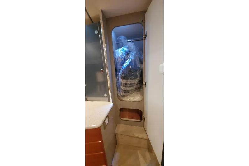  Yacht Photos Pics 2010 Formula 31 Performance Cruiser interior storage compartment with wrapped items.