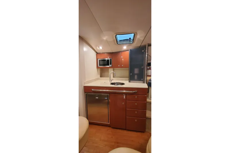  Yacht Photos Pics 2010 Formula 31 Performance Cruiser interior kitchen with modern amenities and wood cabinetry.