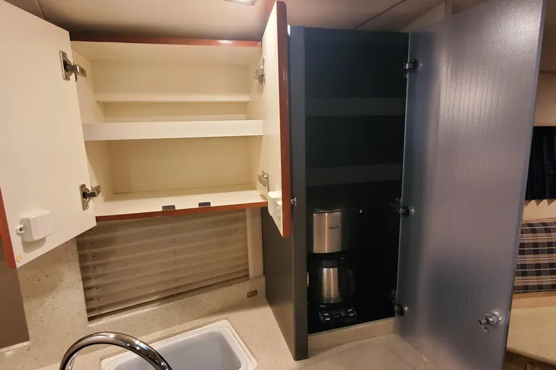  Yacht Photos Pics 2010 Formula 31 Performance Cruiser kitchen with open cabinets and coffee maker.