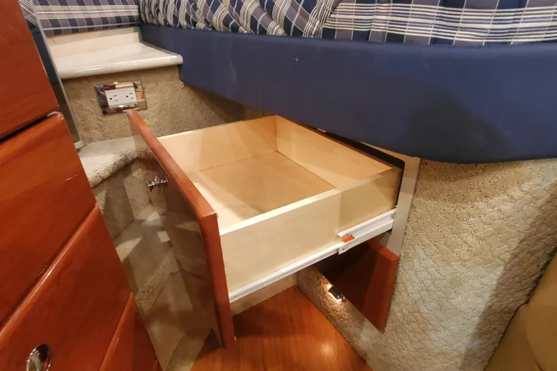  Yacht Photos Pics 2010 Formula 31 Performance Cruiser interior with open wooden drawer under bed.